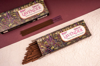 Two boxes of Balaji Lavender incense sticks on a textured surface with a maroon background