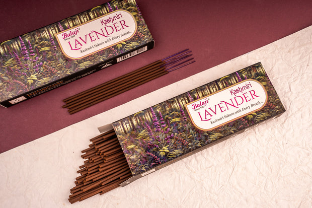 Two boxes of Balaji Lavender incense sticks on a textured surface with a maroon background