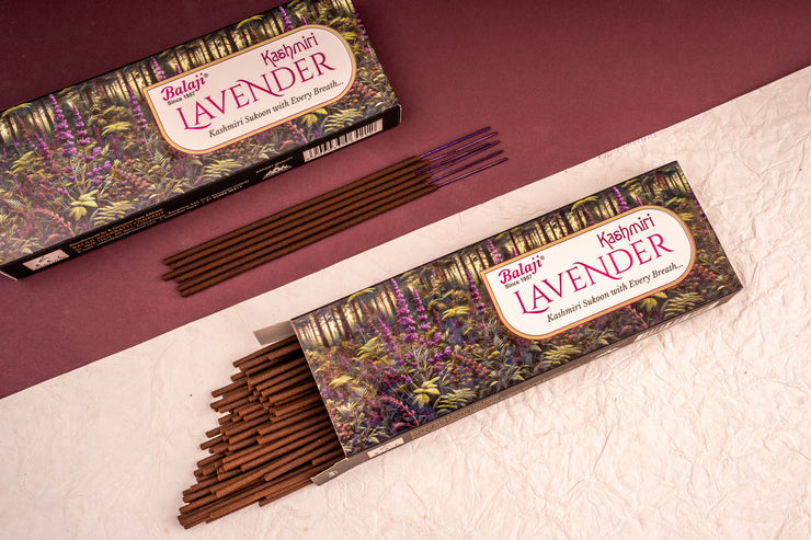 Two boxes of Balaji Lavender incense sticks on a textured surface with a maroon background