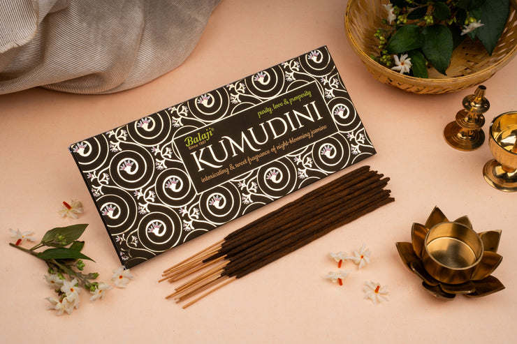 Kumudini incense sticks packaging with incense sticks on a decorative surface
