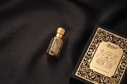 Perfume bottle and packaging on a dark fabric background